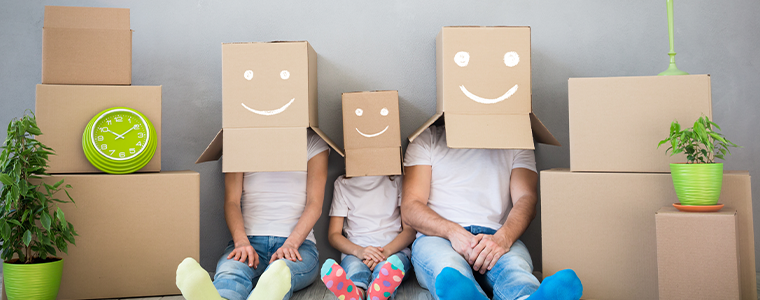 Happy family playing into new home. Father, mother and child having fun together. Moving house day and "think outside the box"